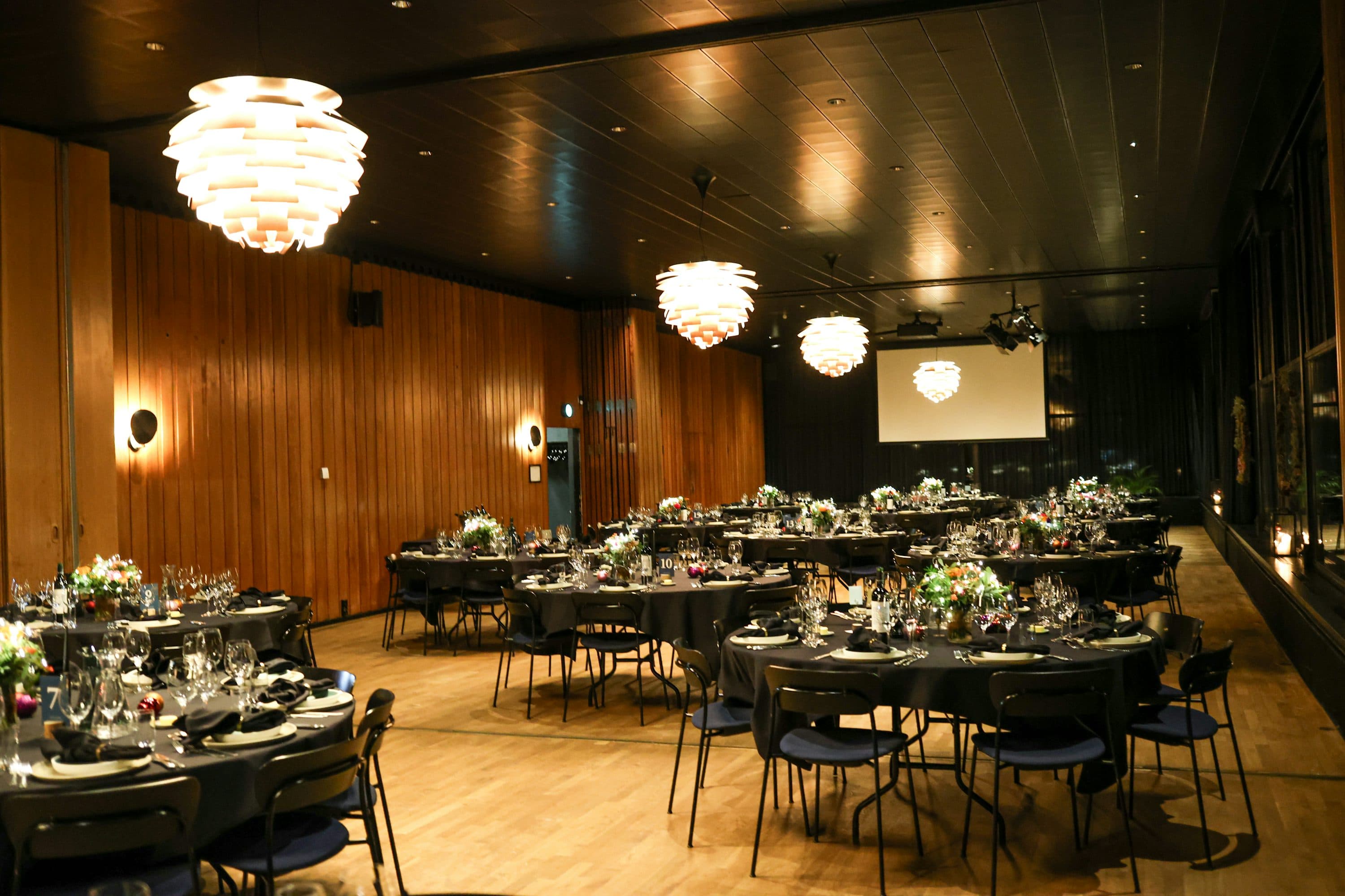 Event venue set up for a function with tables and lighting