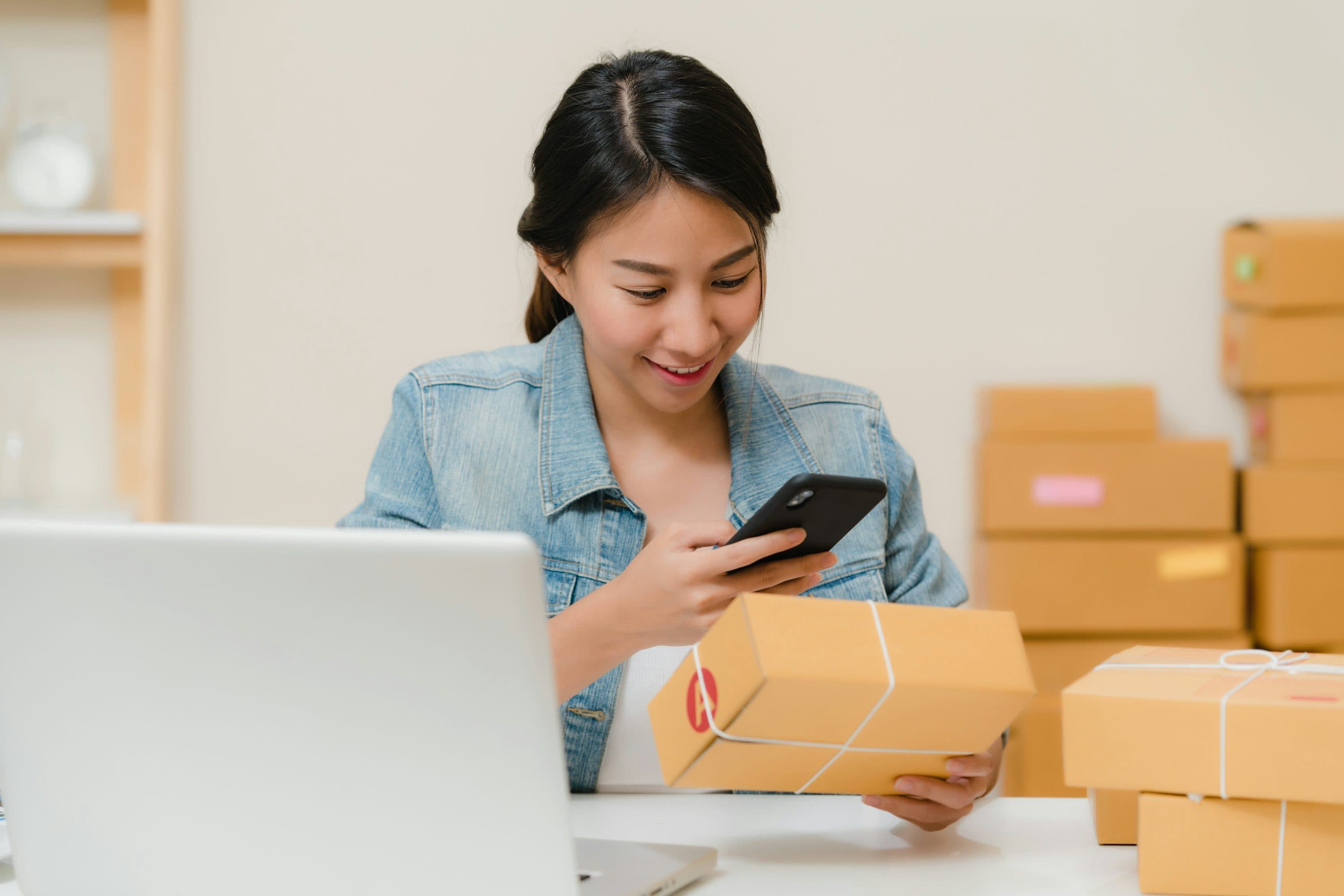 Small business owner packing online orders for shipping