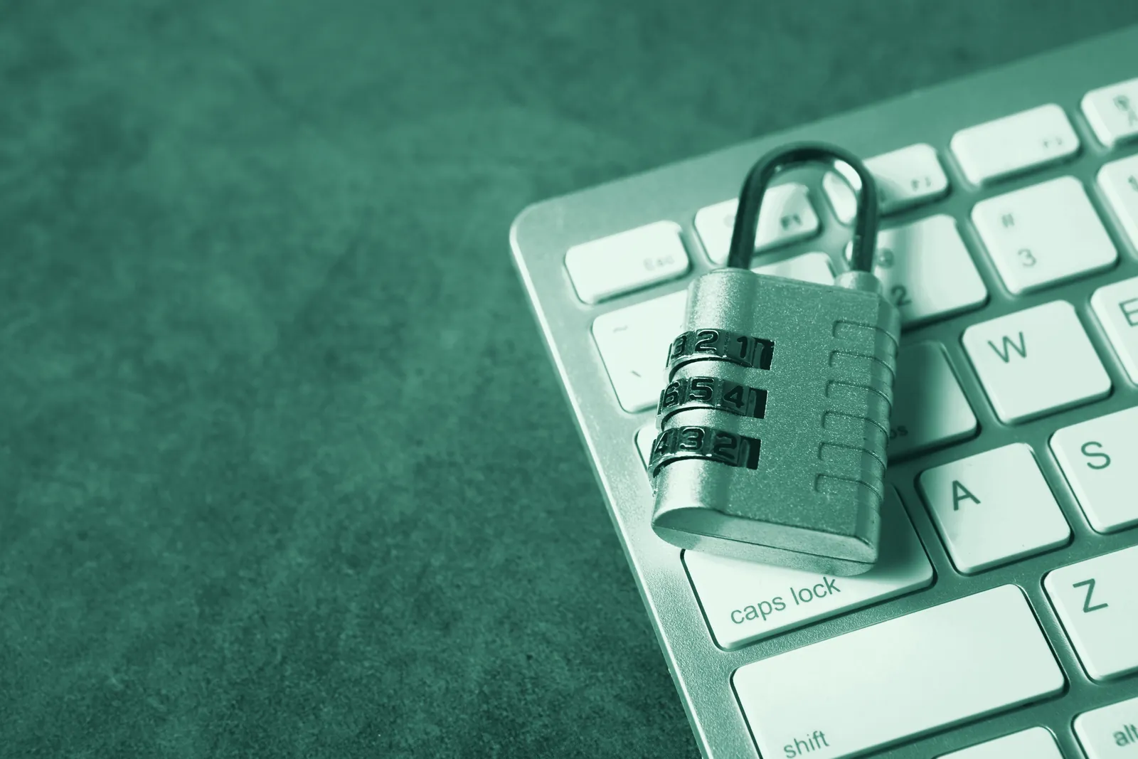 Illustrative photo: a combination padlock resting on a computer keyboard.
