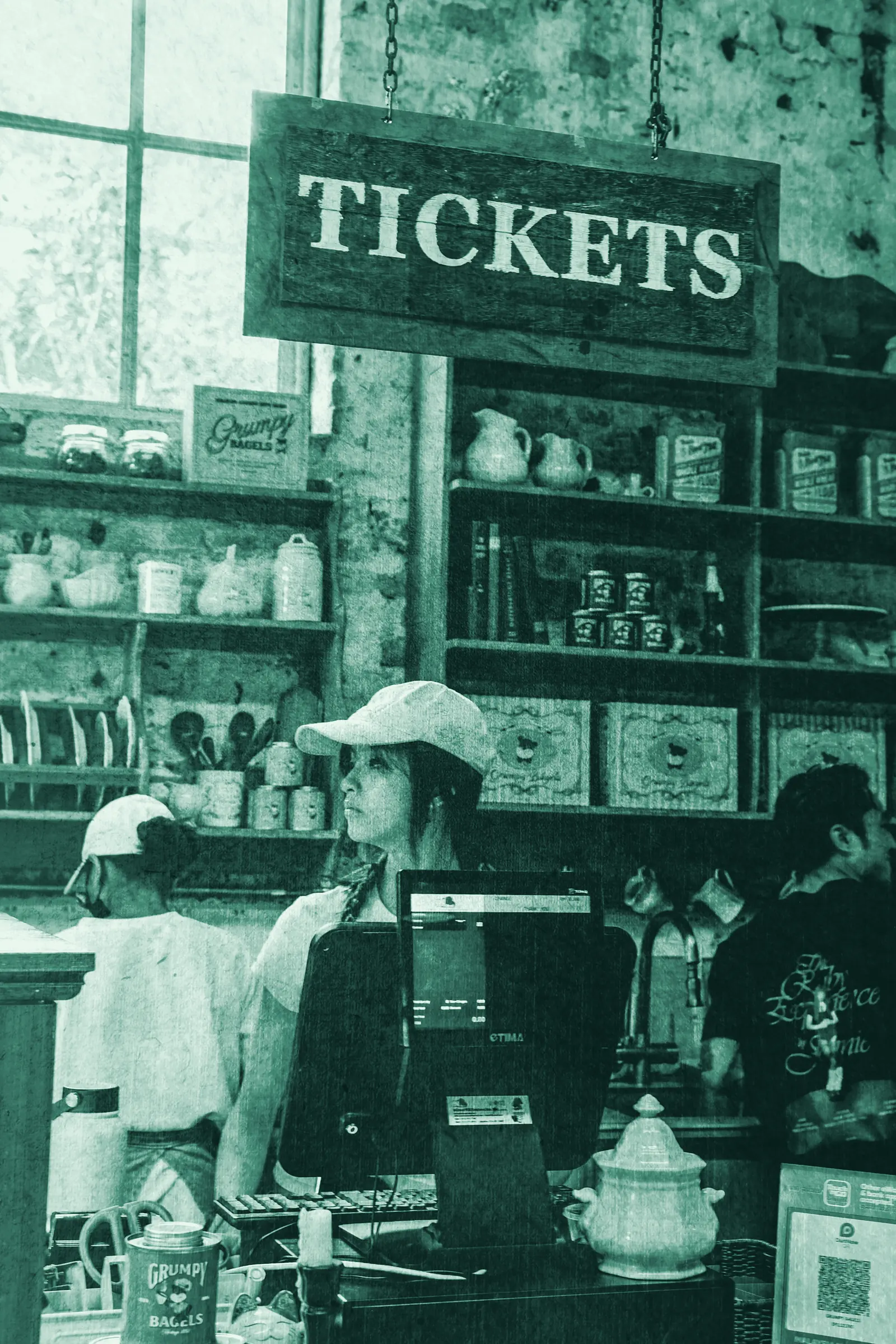 Illustrative photo: a shop owner ringing up a sale at the counter.