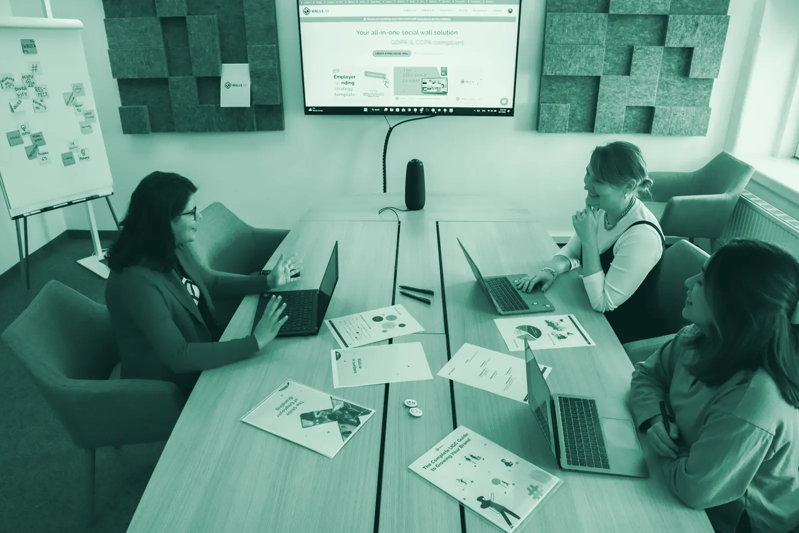 Illustrative photo: a small team working together around a table.