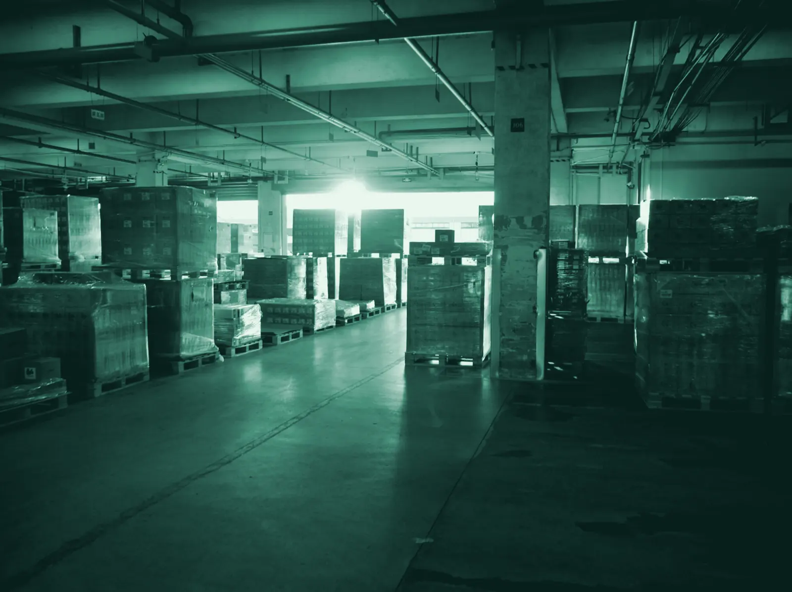 Illustrative photo: boxes and pallets ready for dispatch in a small warehouse.